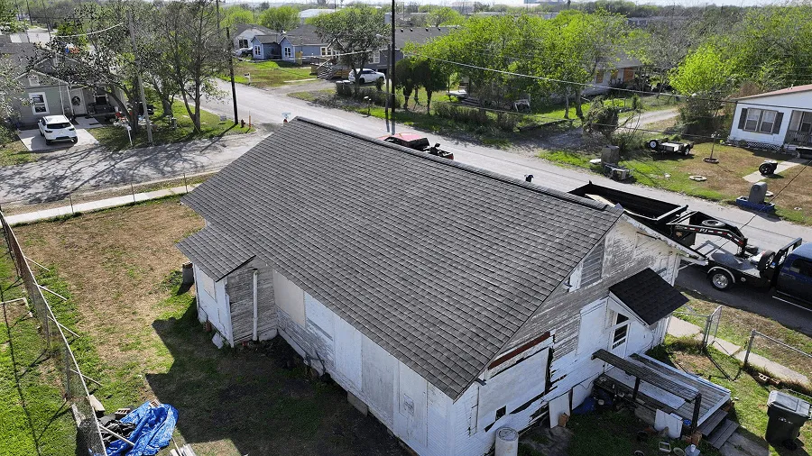Aerial view of a completed asphalt shingle roof replacement in Central Texas